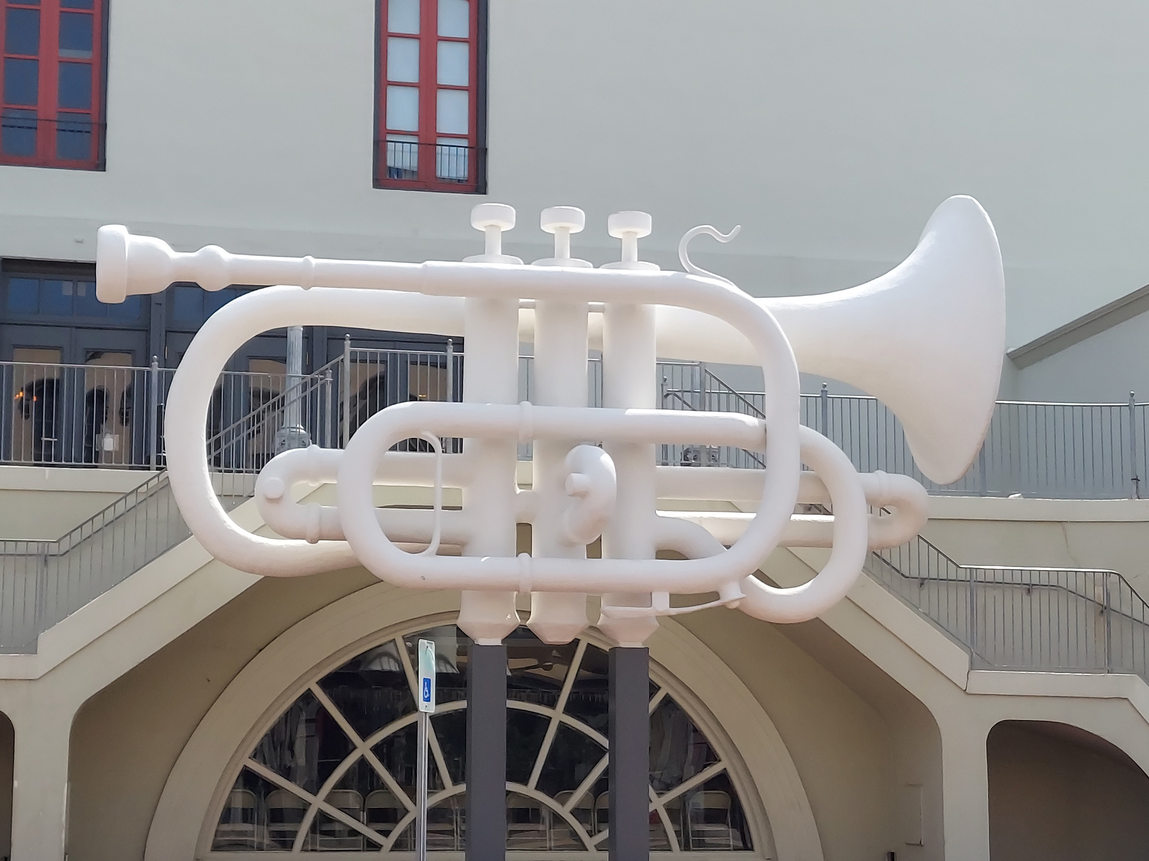 Grandeur in Iron: The Giant Trumpet Sculpture Gracing Old Galveston Square, a Stunning Landmark.  Learn more with an historic waking tour from Galveston Tour Company